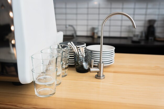 A kitchen countertop and a sink with dishes.