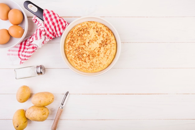 Kitchen table with pie and ingredients