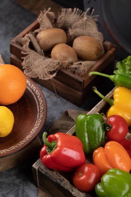 Kiwies and color peppers in rustic trays.