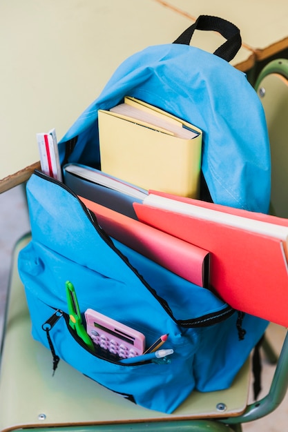 Free photo knapsack with books on chair