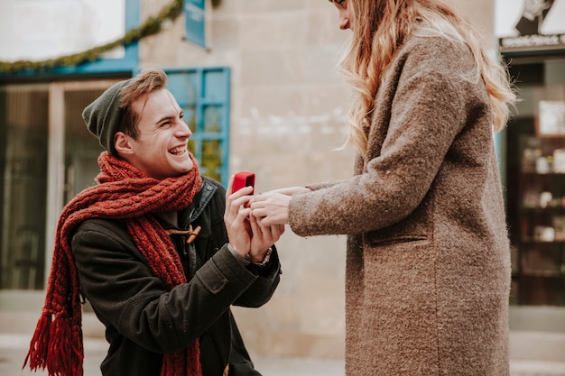 Kneeled man with ring making proposal