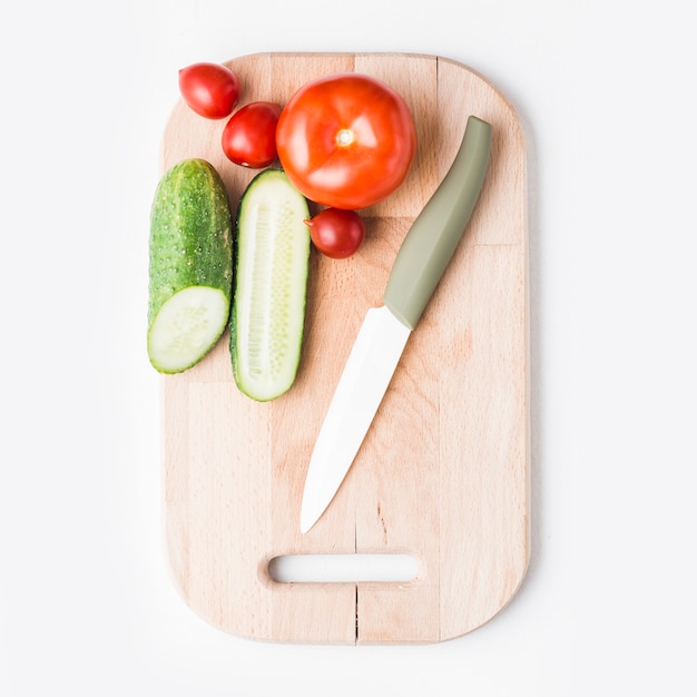 Free Photo knife near cucumbers and tomatoes