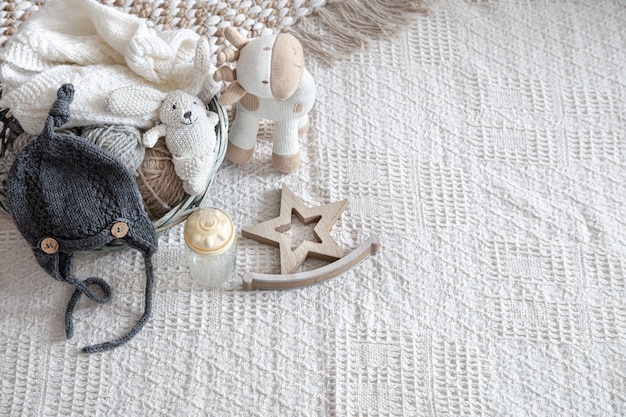 Knitted children's clothing on a light background with accessories