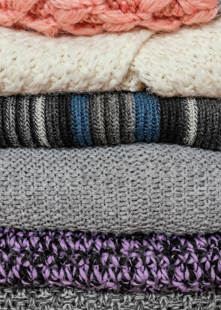 Knitted clothes stacked close up