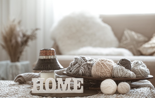 Knitting threads on the table and Home wooden letters