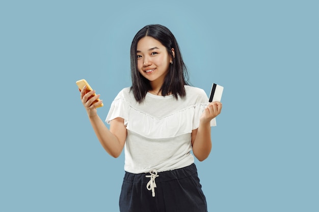 Korean young woman's half-length portrait on blue background