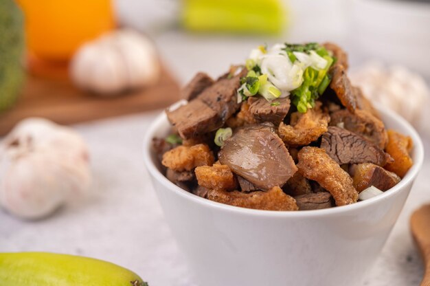 Kuay Jab  in a cup with pork Meatball and Pork Cracker.