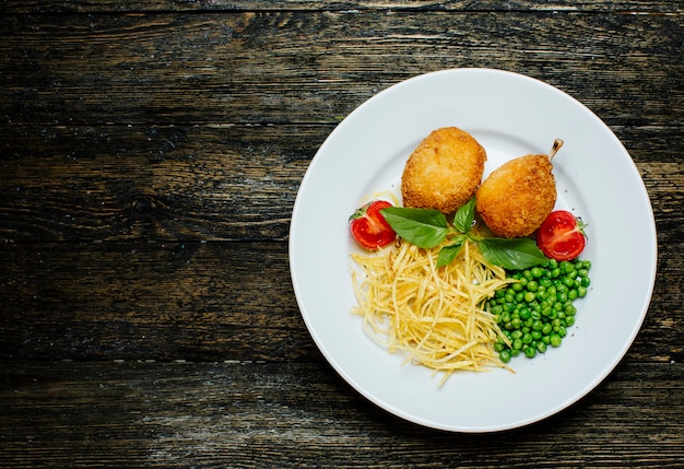 Kyev cutlets with bone, green beans and noodles