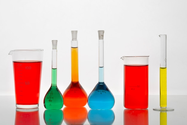 Free photo lab glassware containing colored liquids assortment