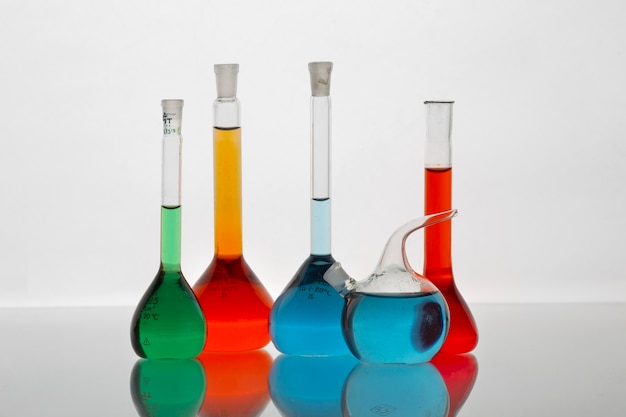 Lab glassware containing colored liquids still life