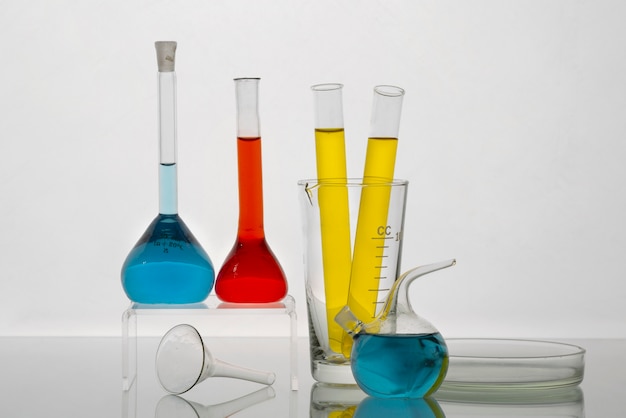 Free Photo lab glassware with colored liquids and white background