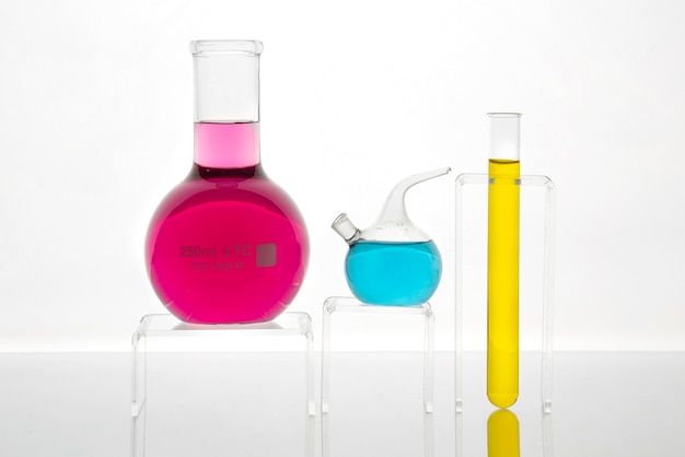 Free photo laboratory glassware with colorful substance on table