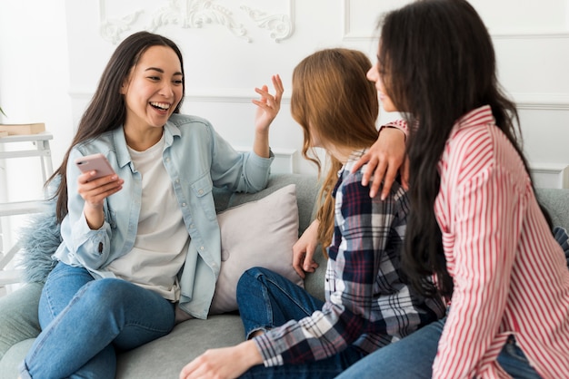 Ladies sitting on sofa and chatting 