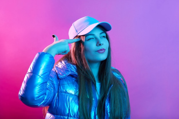 Free Photo lady against pink neon wall with imaginary gun near temple, shooting to her head with fingers