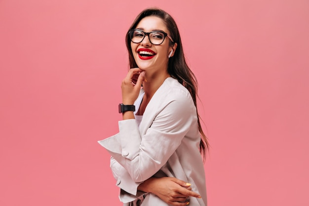 Lady in great mood laughing on pink background.  Cute long-haired woman with beautiful smile in black watch looks at camera.