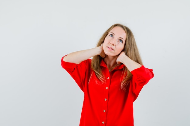 Lady having neck pain in red shirt and looking tired ,