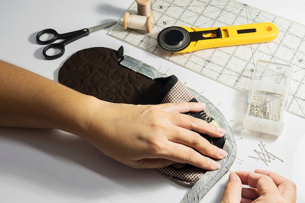 Lady is making handmade cloth soft shoe