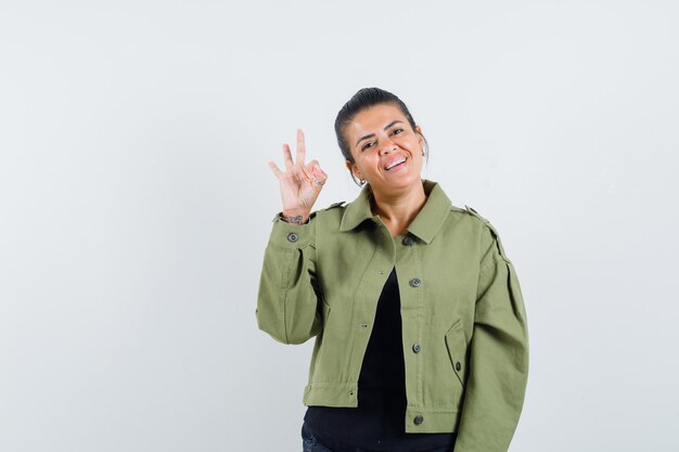 Lady showing ok gesture in jacket