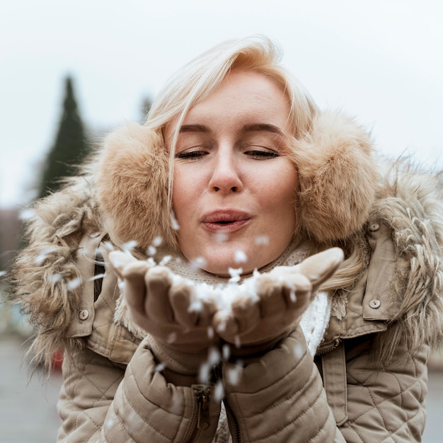 Free Photo lady in winter blowing in the snow