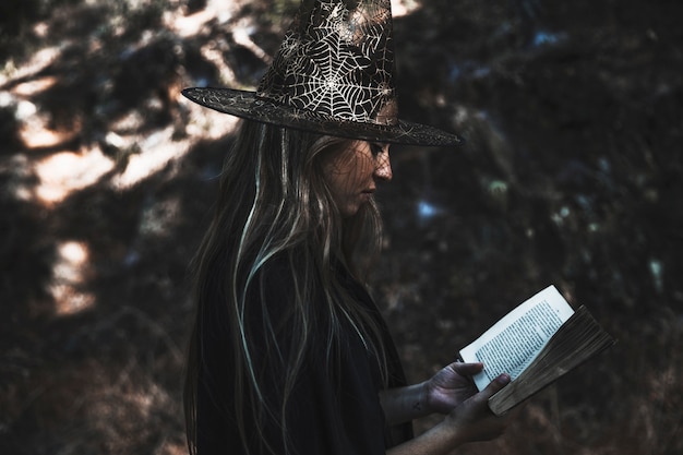 Lady in witch costume reading book