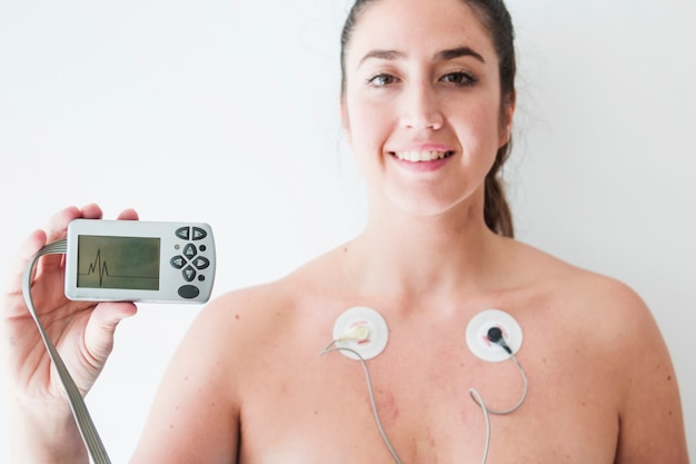 Free photo lady with electrodes holding monitor with cardiogram