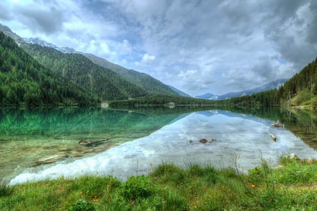 Lake Near Mountain Covered in Trees