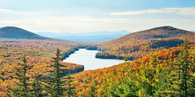 Lake with Autumn foliage viewed from mountain top in New England Stowe