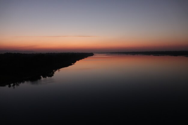 Lake with shore at sunset