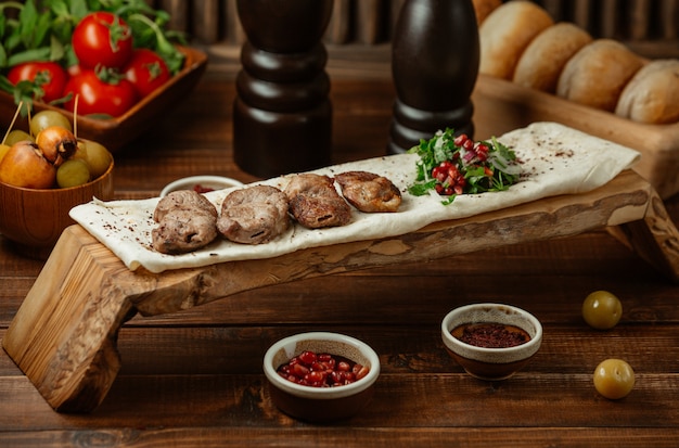 Free photo lamb kebab served on a piece of lavash