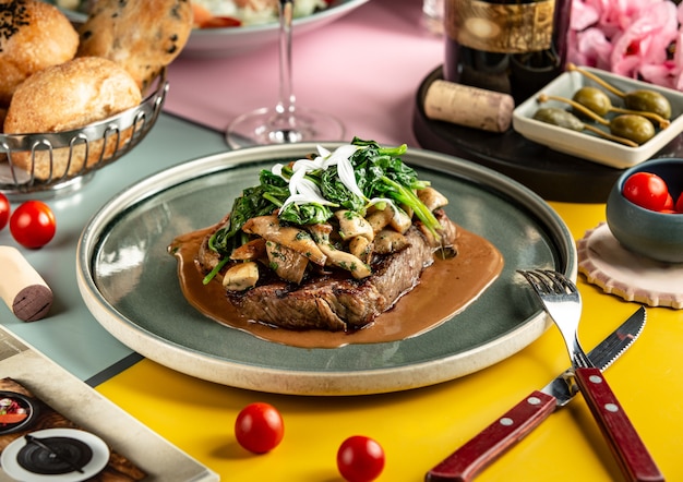 Lamb steak topped with sauteed mushroom and spinach