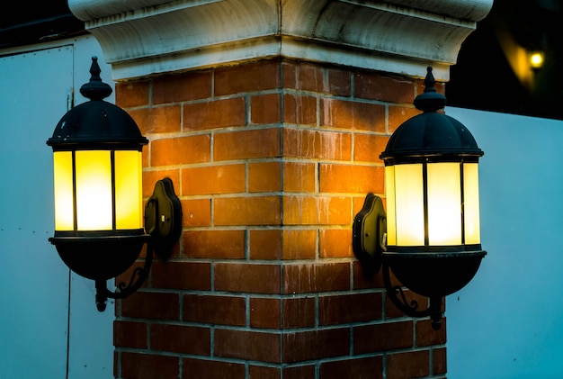 Free Photo lamp against a red brick wall at night.