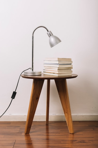 Free photo lamp on table near books