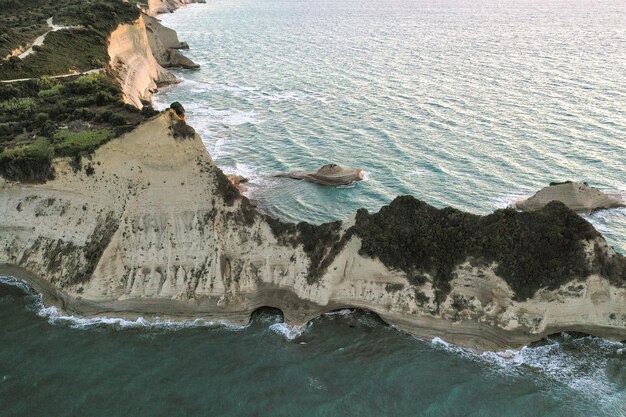 Landscape of cliffs with natural arches surrounded by the sea on a sunny day