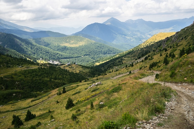 Free photo landscape of hills covered in greenery with rocky mountains