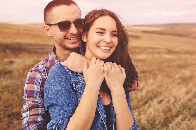 Landscape portrait of young beautiful stylish couple sensual and having fun outdoor