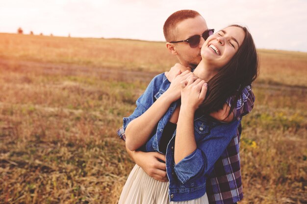 Landscape portrait of young beautiful stylish couple sensual and having fun outdoor