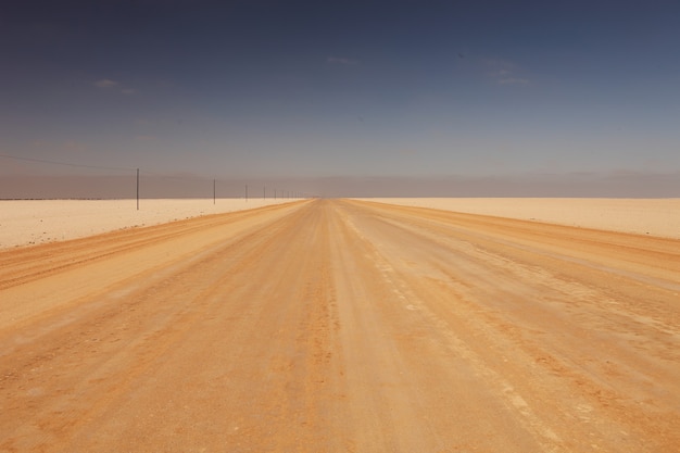 Free photo landscape of a road in a desert under the sunlight at daylight