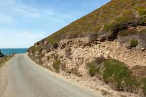 Free photo landscape of a road mountain with blue sea and sky