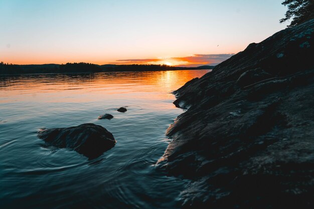 Landscape of a rocky shore surrounded by the sea during a beautiful sunrise in the morning