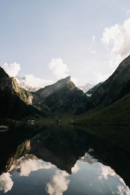 Free Photo landscape shot of mountains and hills with their reflections shown in a lake under a clear sky