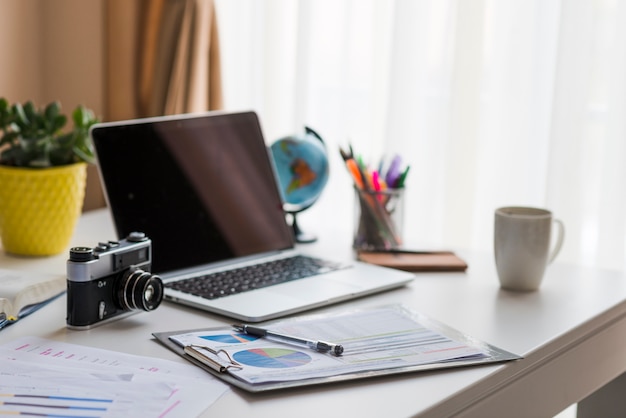 Laptop and camera on office table