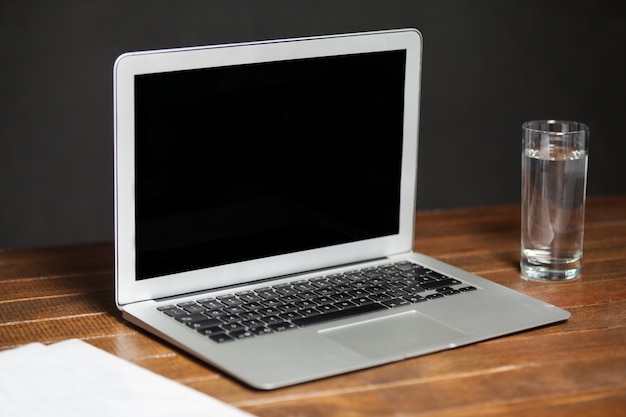 Free photo laptop and glass of water