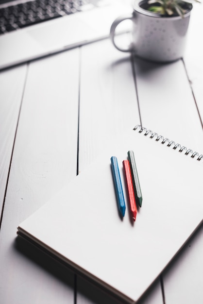 Laptop and notepad composition on desk