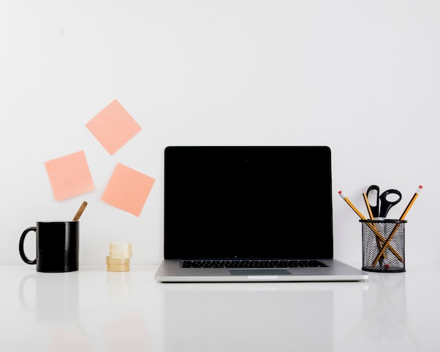 Free Photo laptop on reflective desk in office