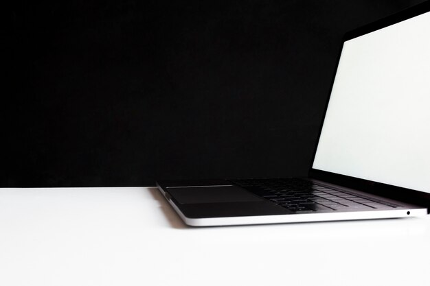 LAptop on top of a work table on black