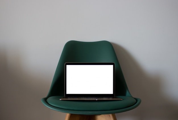 Free Photo  laptop with blank screen on chair