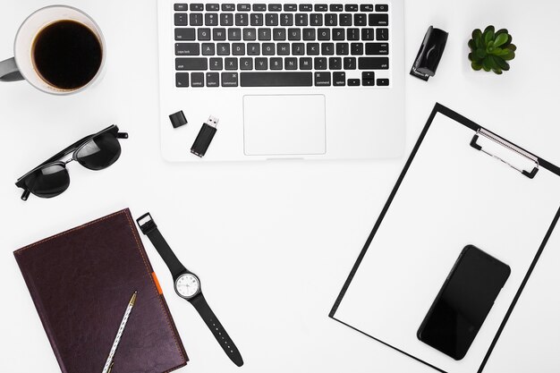 Free photo laptop with clipboard on table