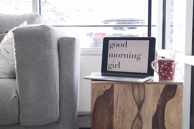 Free photo laptop with coffee cup on table