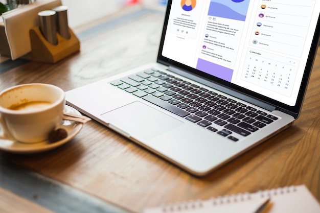 Free photo laptop with coffee cup on table