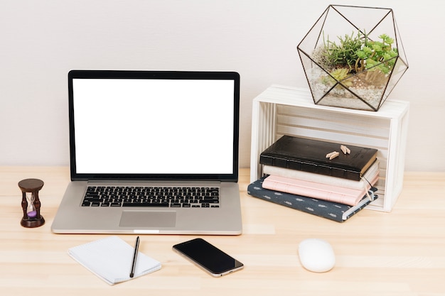 Free photo laptop with notebooks on wooden table